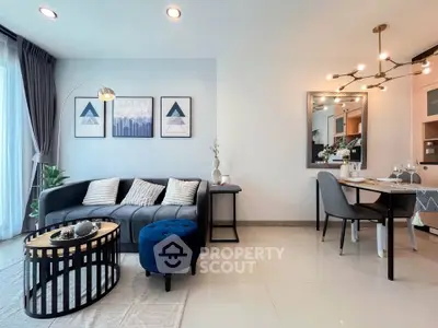 Modern living room with stylish decor and dining area, featuring elegant lighting and contemporary furniture.
