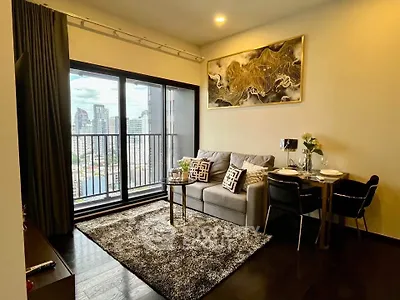 Modern living room with city view, stylish decor, and cozy seating area.