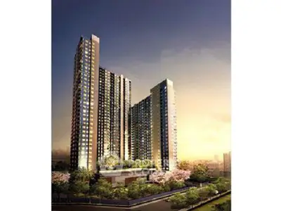 Stunning high-rise residential building with modern architecture and lush greenery.