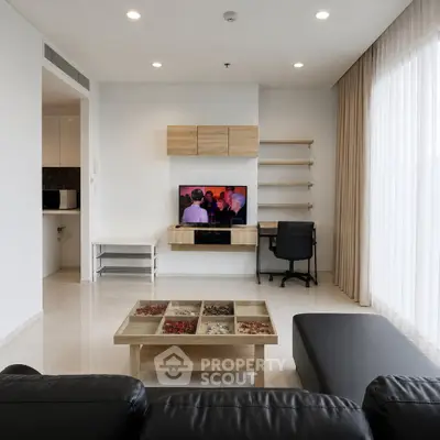 Modern living room with sleek furniture and large window for natural light