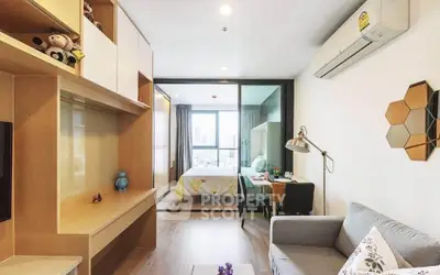 Modern living room with stylish decor and view into cozy bedroom