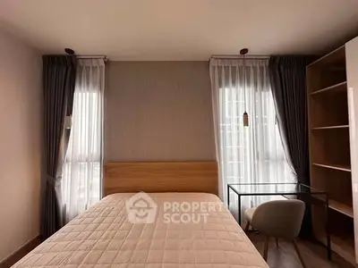 Modern bedroom with elegant decor and natural light, featuring a cozy bed and stylish desk.