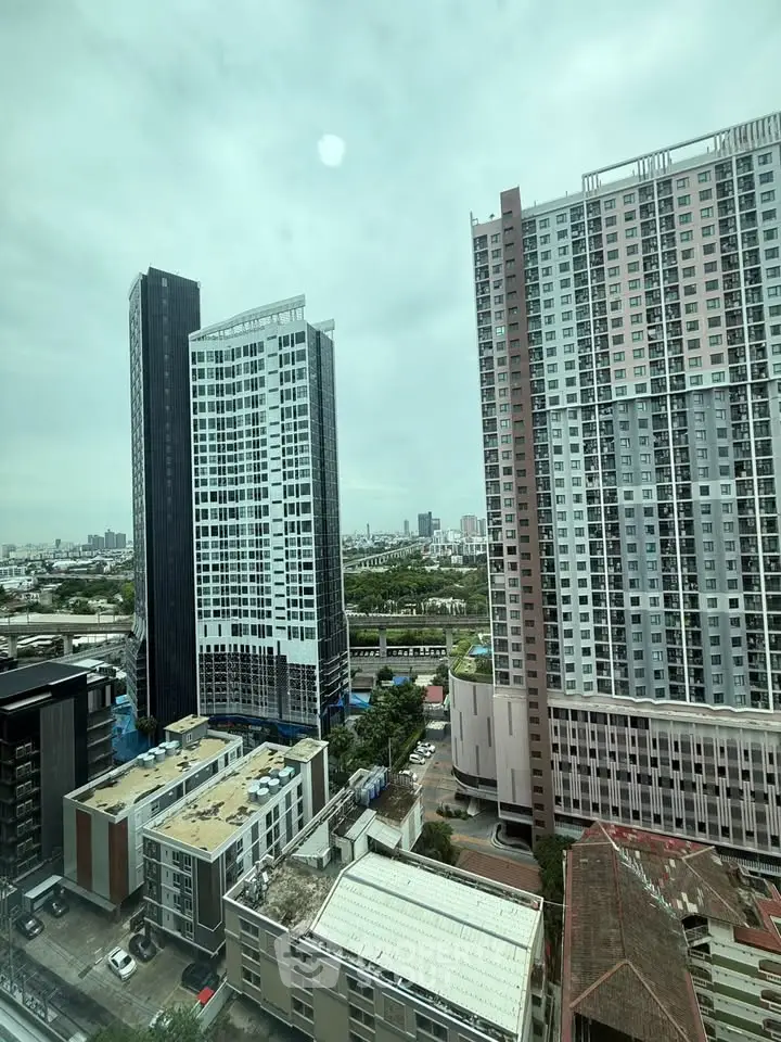 Stunning cityscape view from high-rise apartment showcasing modern architecture and urban skyline.