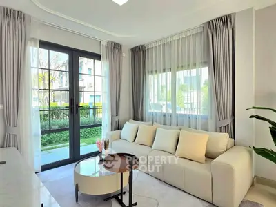 Elegant living room with large windows and modern decor