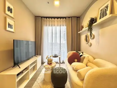 Cozy living room with modern decor, large TV, and natural light from window.