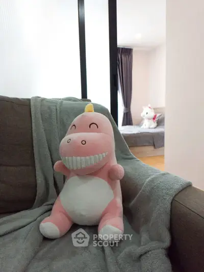 Cozy bedroom with plush toys and soft furnishings, perfect for a child's room.