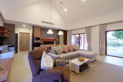 Spacious modern living room with cozy seating and open kitchen layout