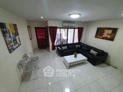 Spacious living room with modern decor and large windows for natural light.
