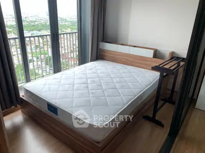 Modern bedroom with large window and city view, featuring a stylish wooden bed frame and sleek flooring.