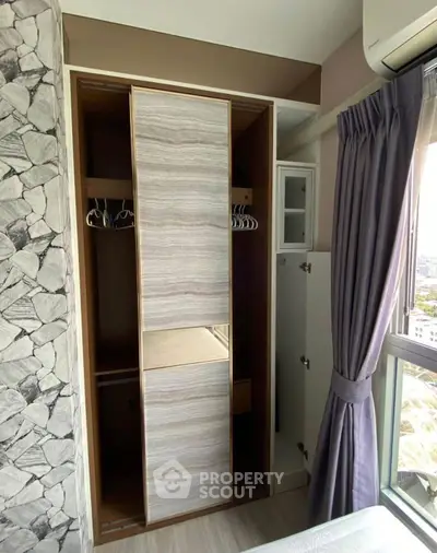 Modern bedroom with stylish wardrobe and large window view