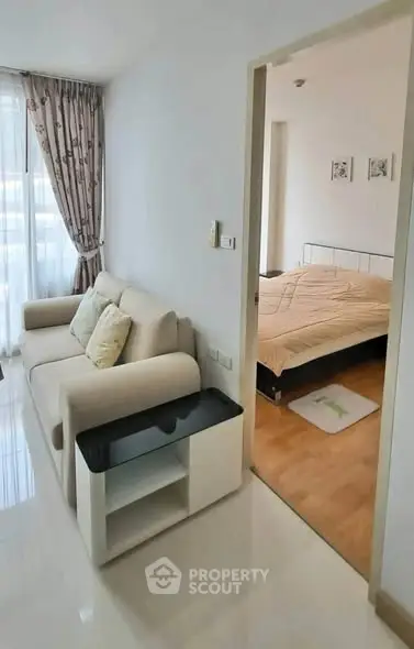 Modern apartment interior with cozy living room and bedroom, featuring elegant decor and natural light.