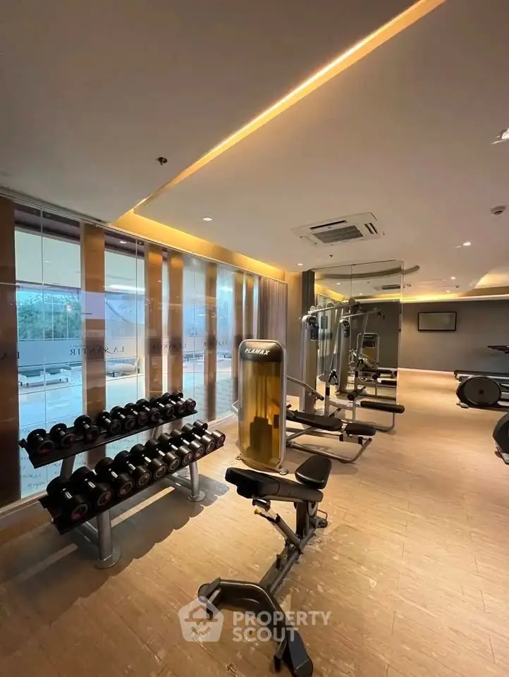 Modern gym with state-of-the-art equipment and sleek design in luxury residential building.