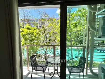 Charming balcony with pool view, perfect for relaxation in a serene environment.