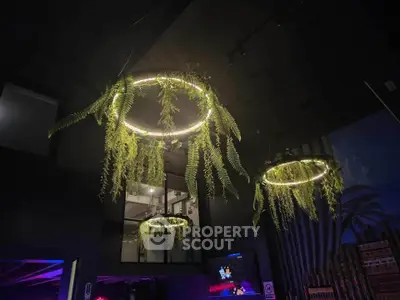 Modern interior with unique hanging light fixtures and greenery, creating a stylish ambiance.