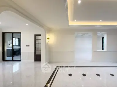 Spacious modern living room with elegant marble flooring and recessed lighting