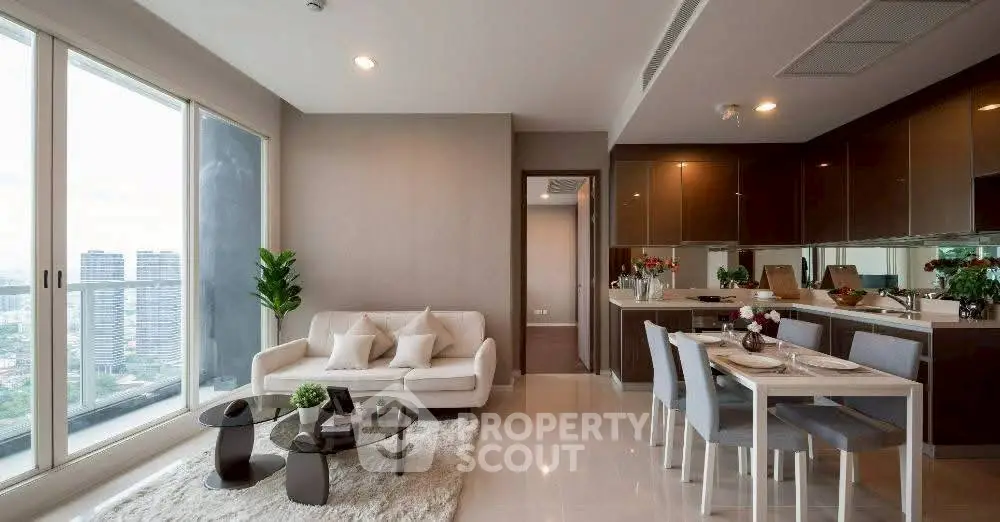 Modern open-plan living room with city view, elegant furniture, and stylish kitchen.