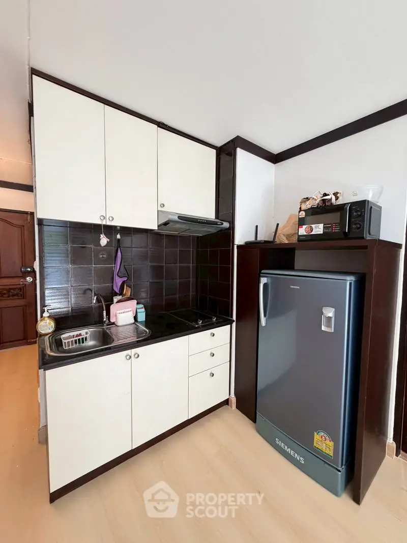 Compact kitchen with modern appliances and sleek cabinetry