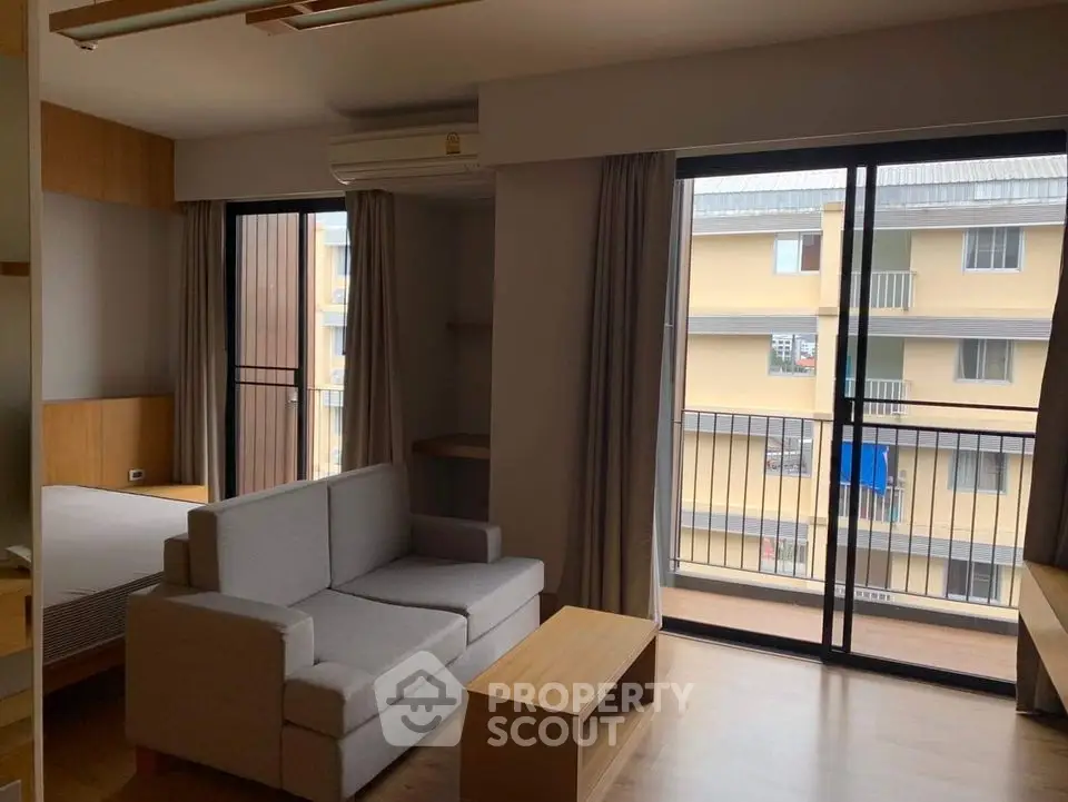 Modern apartment interior with cozy living area and balcony view