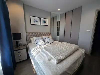 Cozy modern bedroom with stylish decor and ample natural light