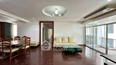 Spacious living room with elegant wooden flooring and modern furniture in a bright apartment.