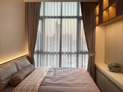 Cozy bedroom with large window and elegant curtains in modern apartment