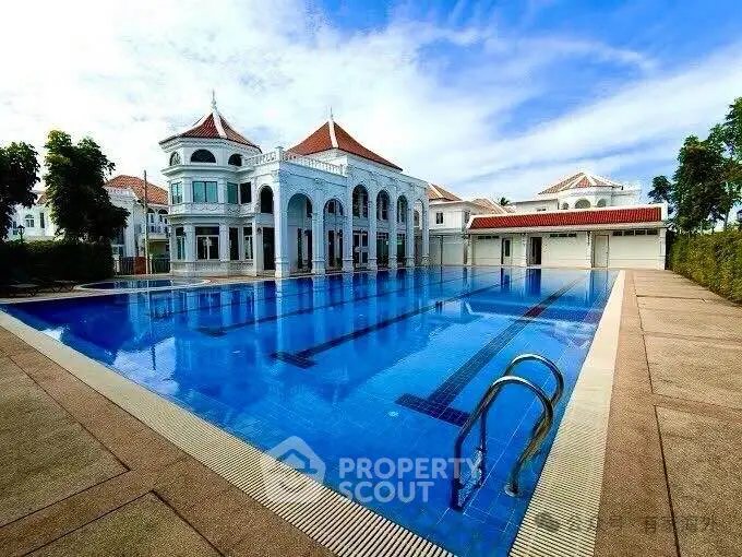 Luxurious villa with stunning outdoor pool and elegant architecture under a clear blue sky.