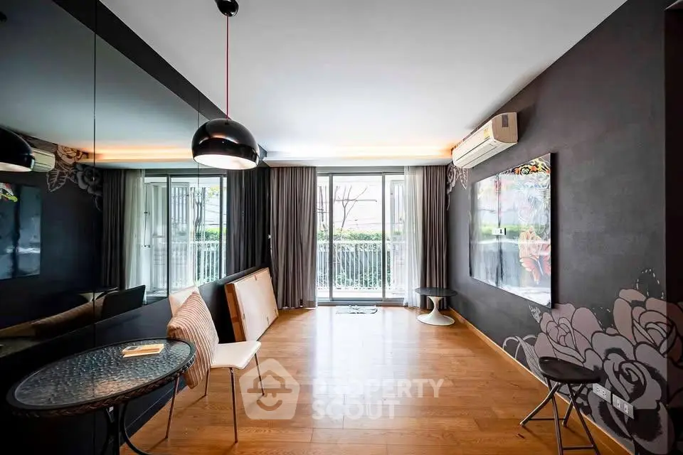 Stylish living room with modern decor and balcony access in a contemporary apartment.