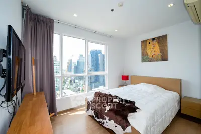 Modern bedroom with city view, featuring stylish decor and natural light.