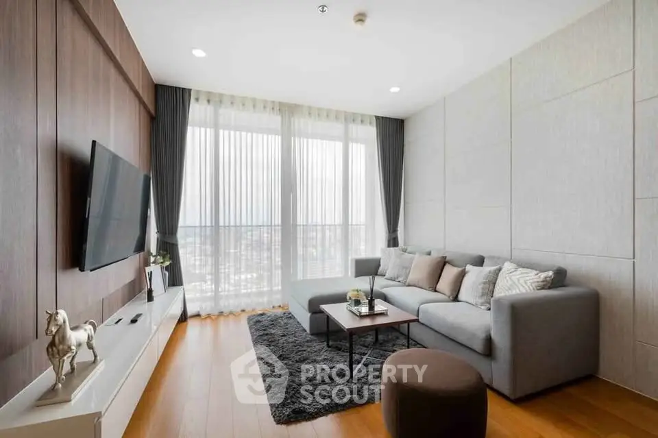 Modern living room with sleek design, large windows, and cozy seating area.