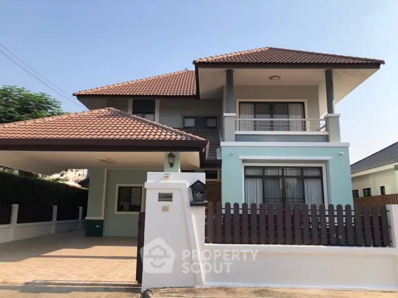 Charming two-story house with red-tiled roof and spacious driveway