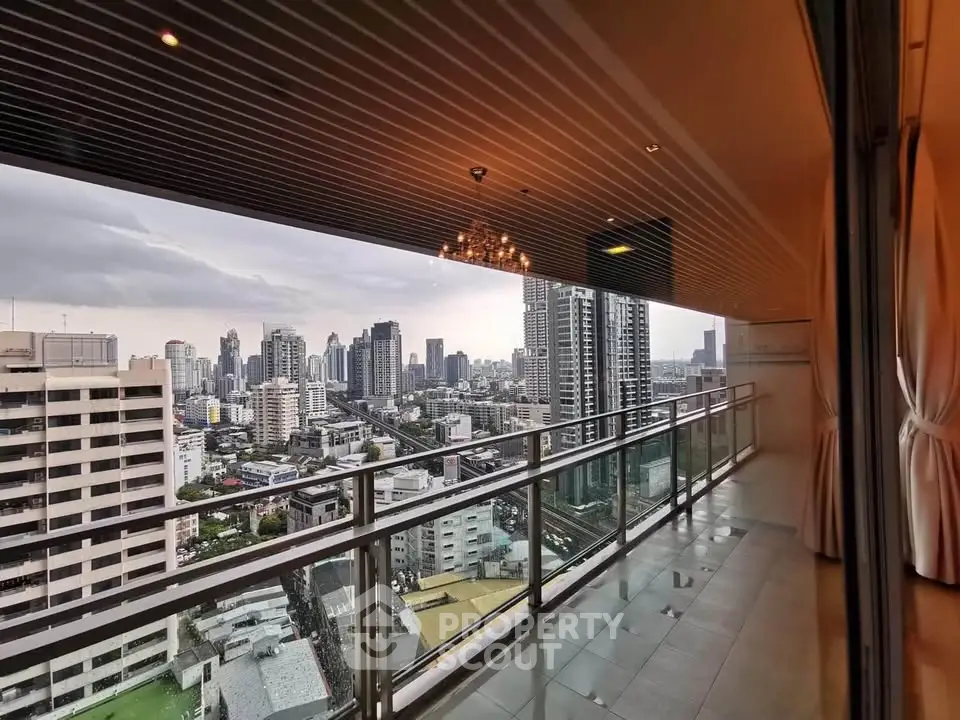 Stunning city view from a spacious balcony in a high-rise apartment