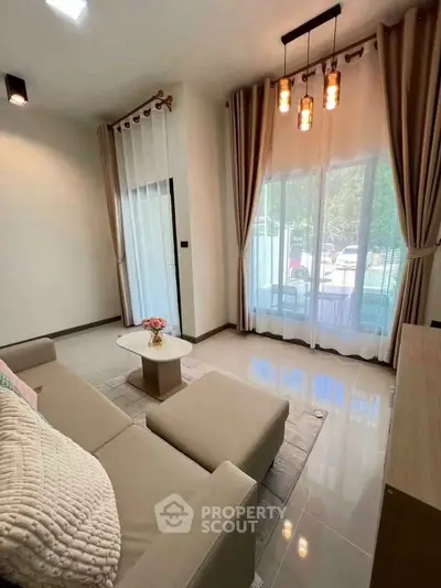 Elegant living room with modern decor and large windows offering natural light.