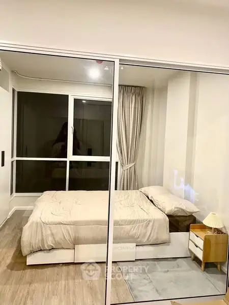 Cozy modern bedroom with glass partition and stylish decor