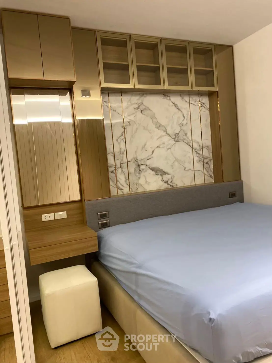 Luxurious bedroom with elegant marble accent wall and modern furnishings