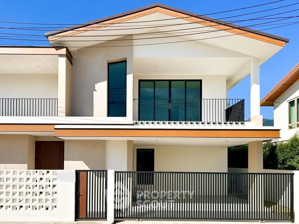 Modern two-story house with sleek balcony and gated entrance