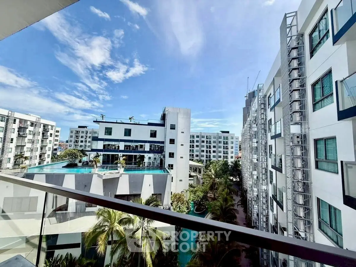 Modern apartment complex with pool and lush greenery, offering a luxurious lifestyle.