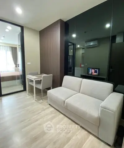 Modern living room with sleek design and cozy ambiance in a stylish apartment.