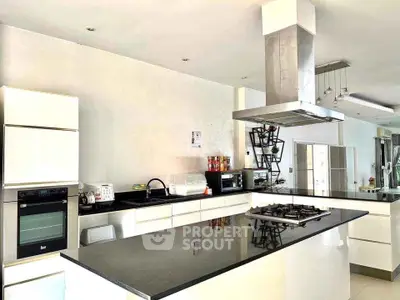 Modern kitchen with sleek design, island counter, and built-in appliances