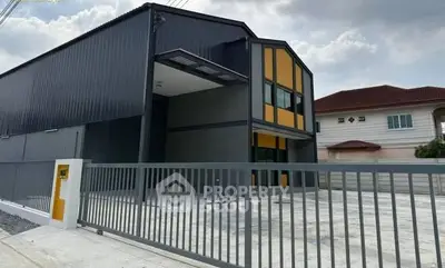 Modern industrial building with sleek design and spacious driveway