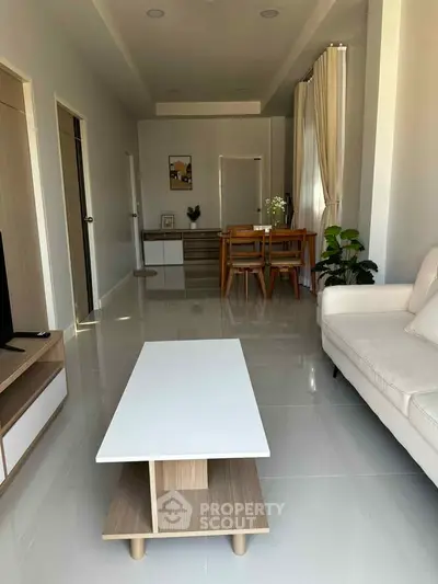 Modern living room with sleek furniture and natural light, perfect for stylish urban living.