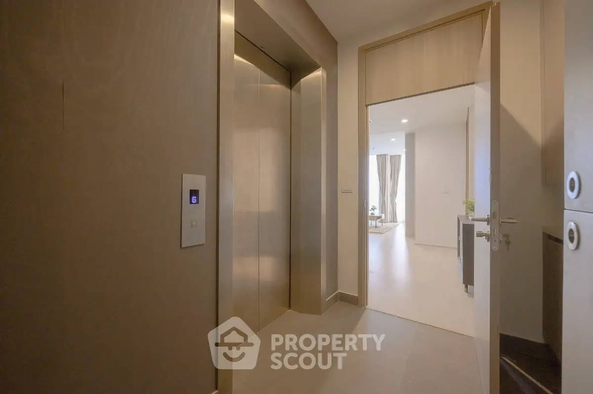 Modern apartment entrance with elevator and open living space