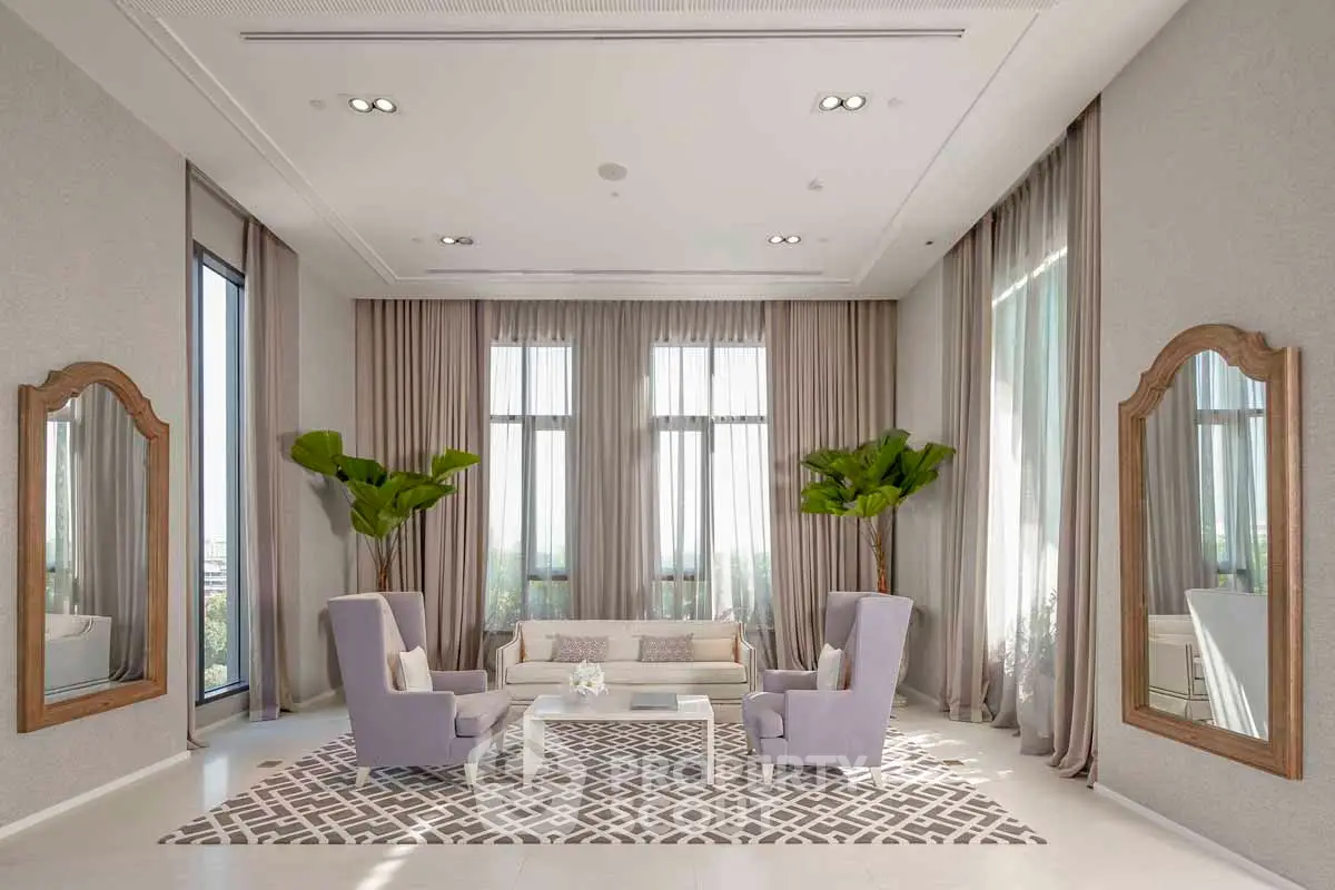 Luxurious living room with high ceilings, elegant decor, and large windows offering natural light.