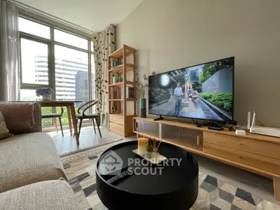 Modern living room with stylish furniture and large window offering city view.