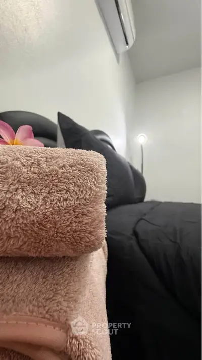 Cozy bedroom with plush bedding and soft lighting, perfect for relaxation.
