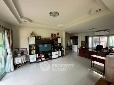 Spacious living room with modern decor and large windows for natural light.