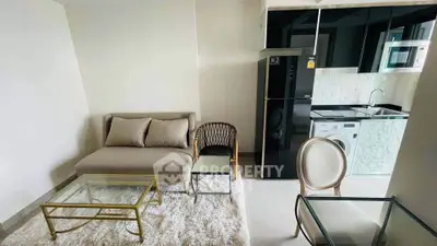 Modern living room with compact kitchen, featuring sleek appliances and cozy seating area.