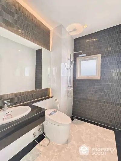 Modern bathroom with sleek black tiles and contemporary fixtures