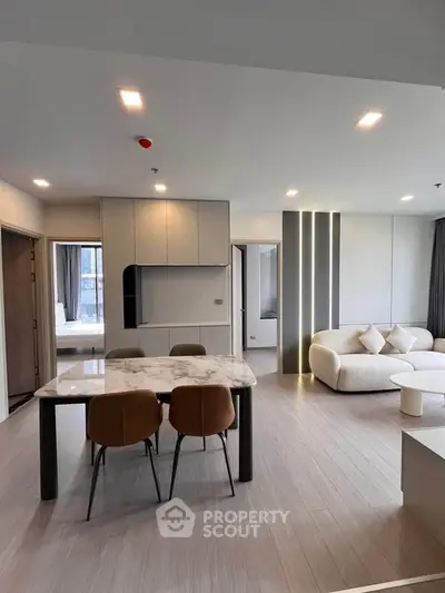 Modern open-plan living room with elegant dining area and stylish furniture