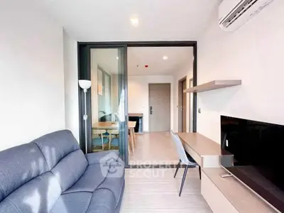 Modern living room with sleek furniture and glass partition in a stylish apartment.