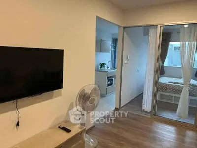 Modern apartment interior with living room, kitchen, and bedroom view.